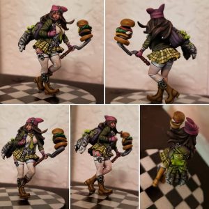 Collage of a miniature figure painted in detail, it's of a girl with burgers on a spatula